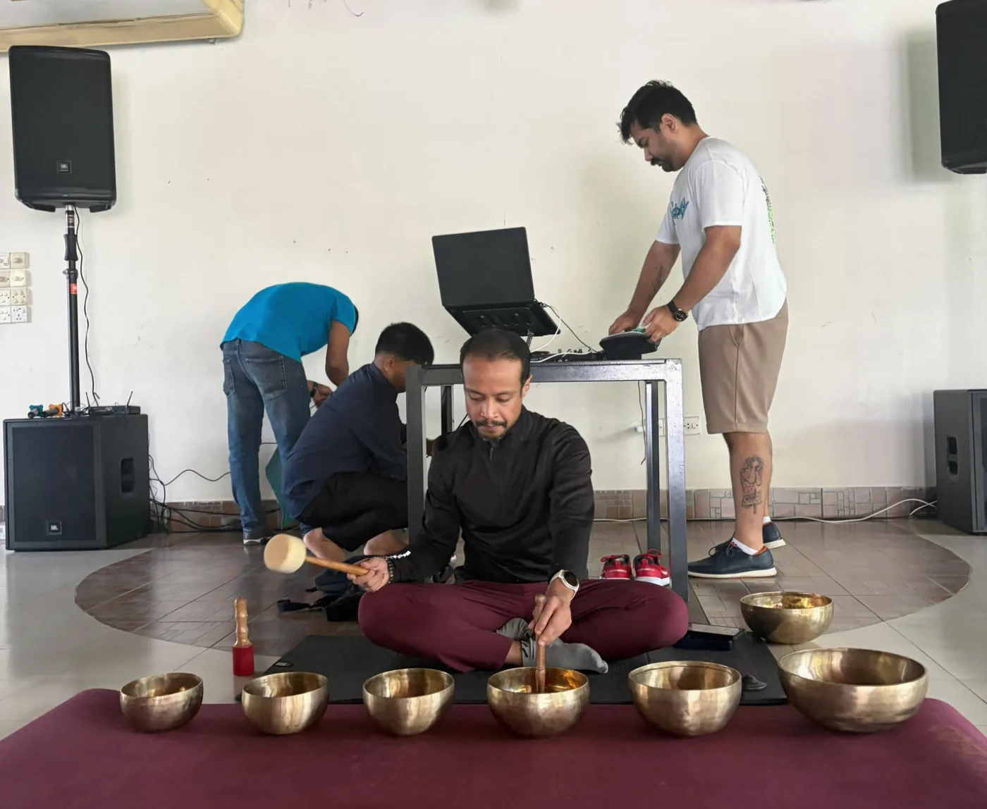Ishtiaque playing sound bowls during a live practice session